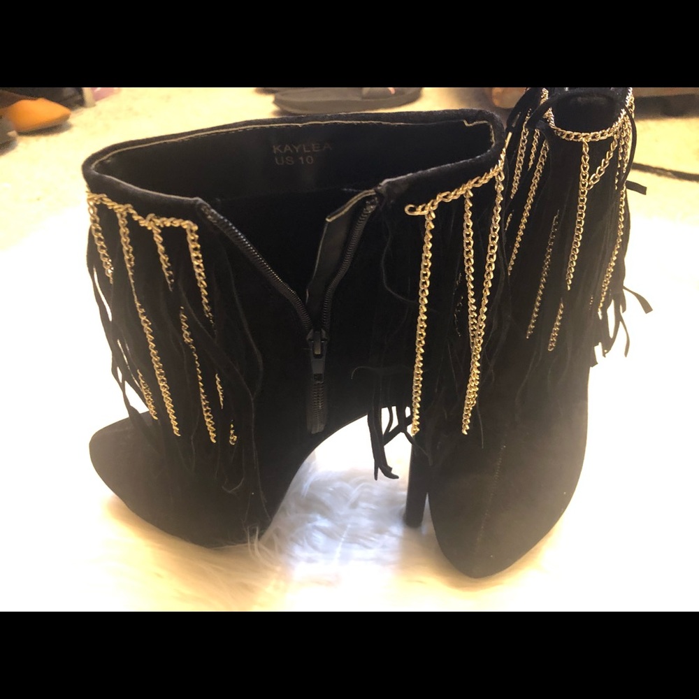 Black booties with gold tassels